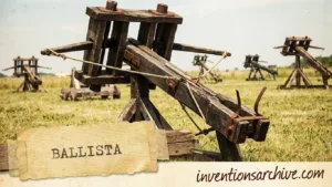 A wooden ballista with large arms, base, and a strap, used as an ancient siege weapon.