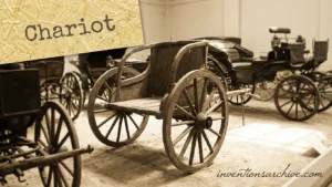 A wooden chariot with large spoked wheels and a simple harness for animals.