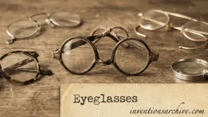 A pair of vintage eyeglasses with round frames and a handwritten label reading 'Eyeglasses'.