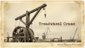 A historic treadwheel crane with a large wooden wheel and crane arm for lifting heavy loads.