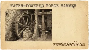 A water-powered forge hammer with large wheel, gears, and striking arm for forging metal.