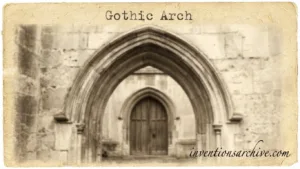 Gothic arch with pointed shape framing a wooden door and stone carvings.