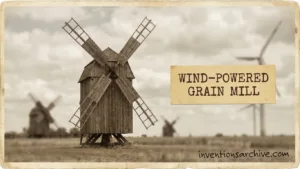 A traditional wind-powered grain mill with large blades turning in the wind.