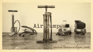 An air pump with a vertical piston, handle, and connected hoses, used for inflating objects.