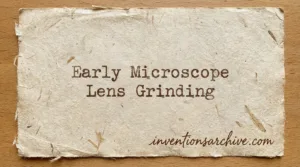 A close-up of a hand-held tool shaping glass for early microscope lens grinding